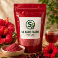 Red package labeled S4 Agro Farms with hibiscus flowers and a cup of tea on a wooden surface.