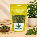 Yellow package of green herbs with S4 Agro Farms label on a wooden surface, plant in background