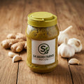 Jar of S4 Agro Farms product on a wooden surface with mustard seeds and leaves.