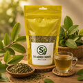 Bag of S4 Agro Farms tea with a cup of tea and leaves on a wooden surface